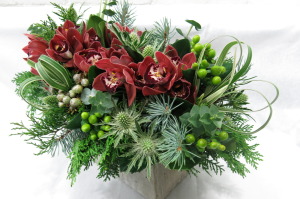 Beautiful centrepiece with cymbidium orchids and thistle